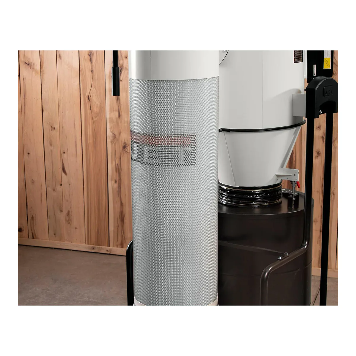 JET JCDC-3 cartridge filter in its expanded metal guard, standing in its own column beside the cyclone cone and the collection drum