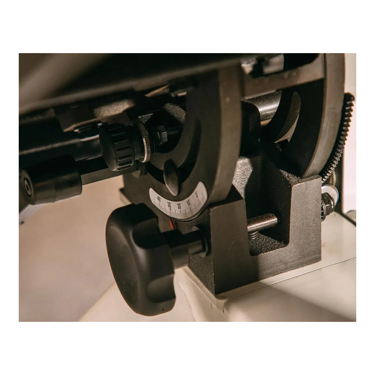 JET JWBS-15 cast iron trunnion under the table, with the tilt scale on the casting and the locking knob beside it