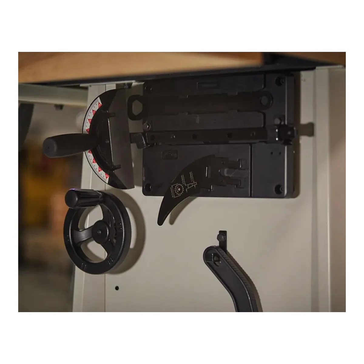 JET ProShop II cabinet side with the miter gauge, the blade guard and riving knife assembly and the push stick hung on it, beside the bevel handwheel
