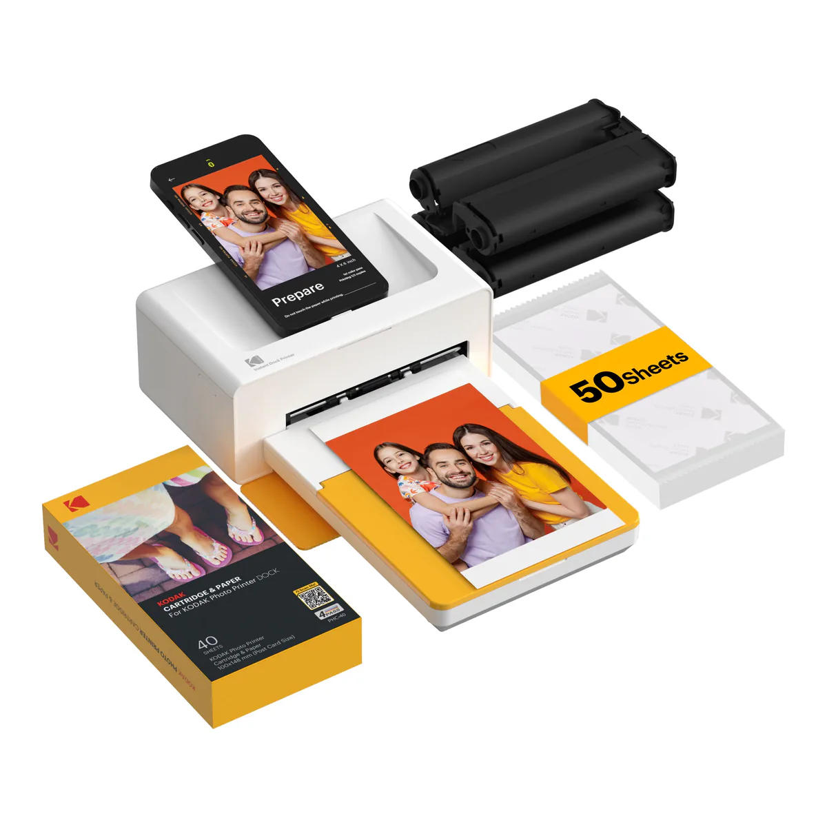 KODAK Dock Plus 4x6 photo printer in white and yellow with a phone docked on top, cartridges and a 50 sheet paper bundle
