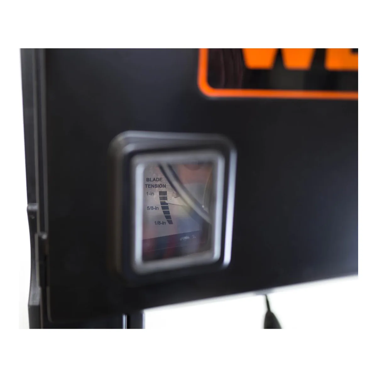 Blade tension gauge window on the WEN BA1487 upper wheel housing, with the scale stepped by blade width