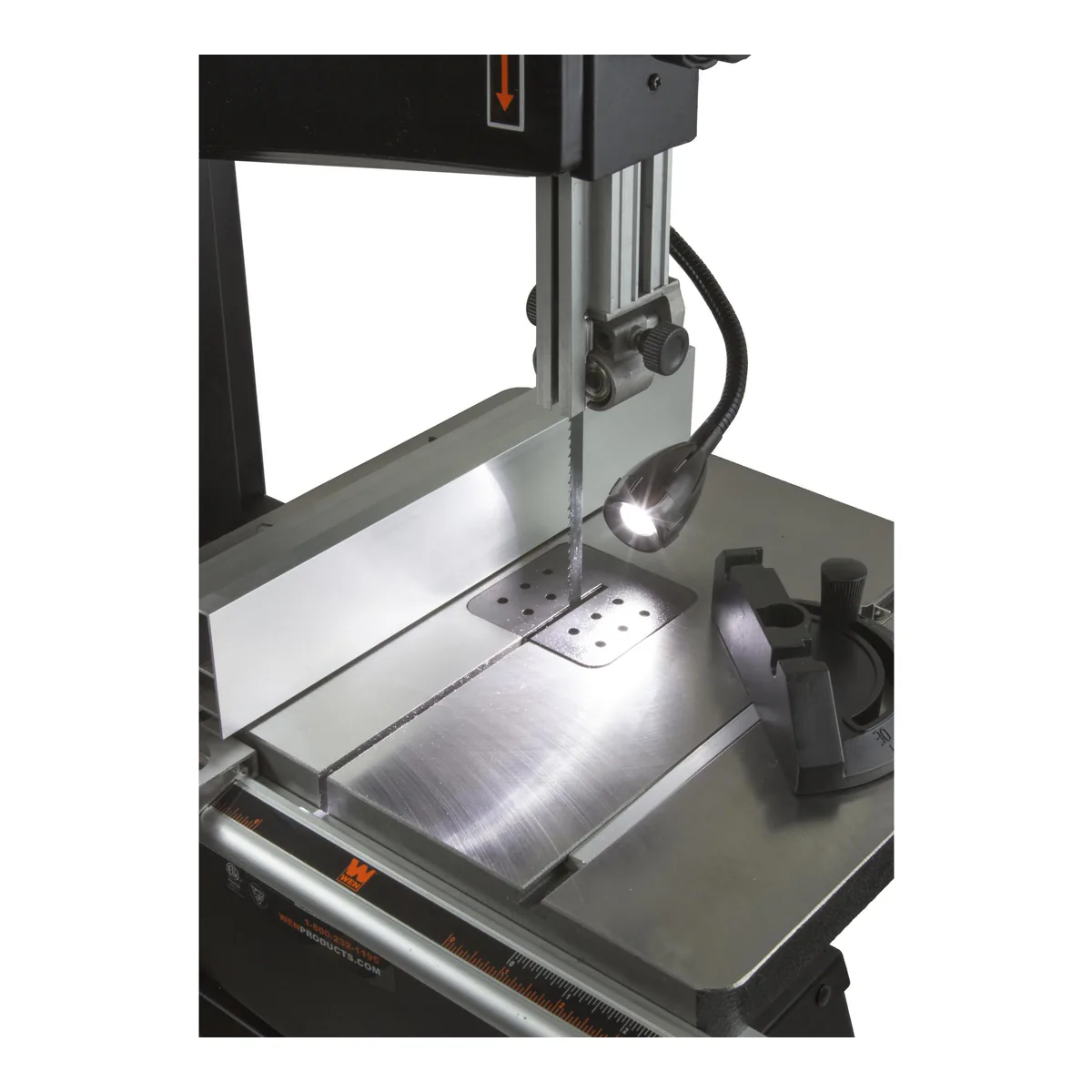 WEN BA3962 bandsaw cast aluminum work table with the rip fence, the miter gauge and the flexible worklight lit over the blade