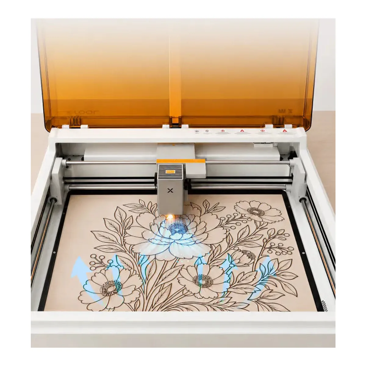 xTool M2 with its amber lid raised, the diode head over a floral engraving on wood filling most of the bed